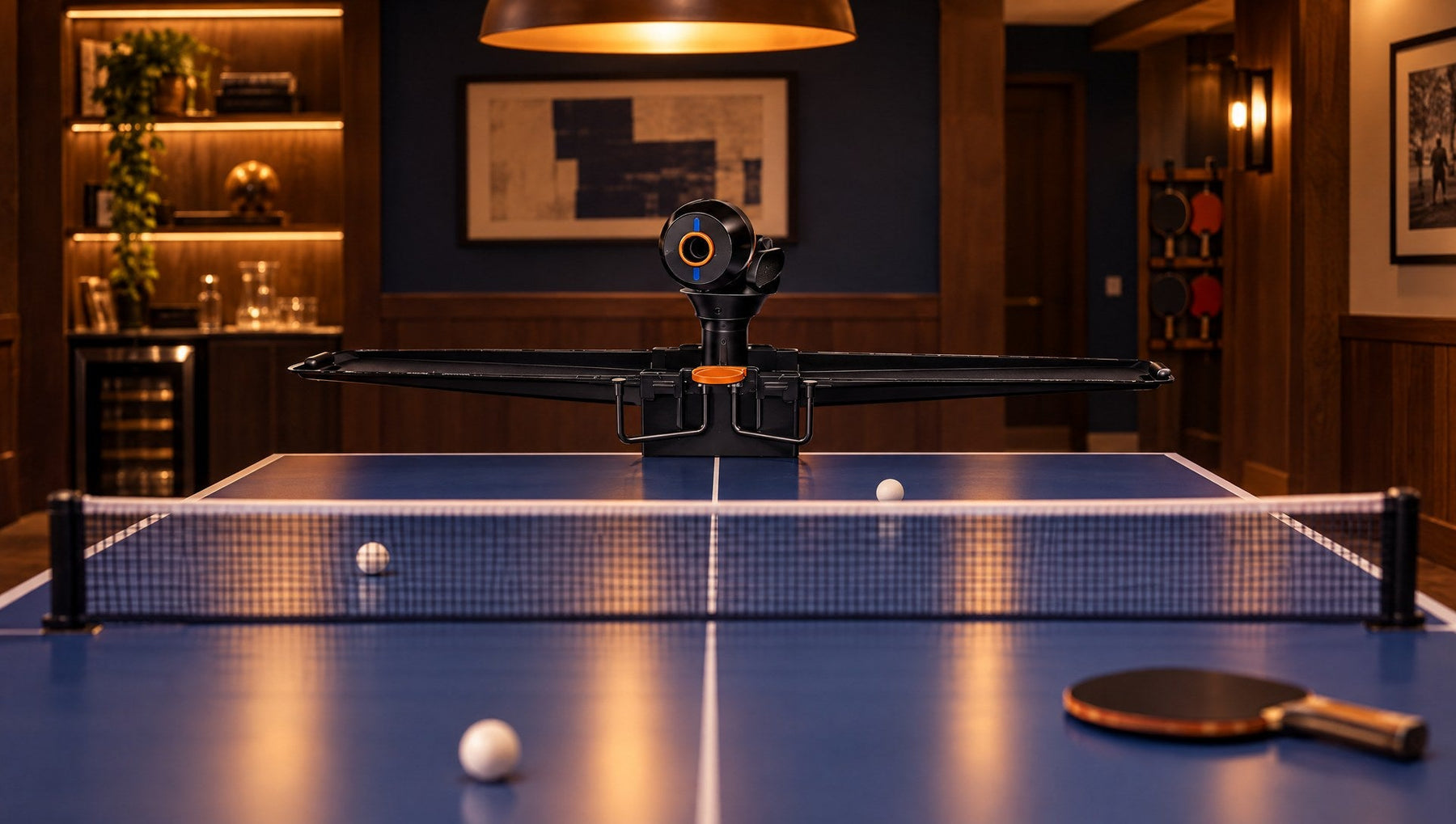 Best ping pong robot 2026: Pongbot Omni S Pro clamped to a blue table in a basement game room