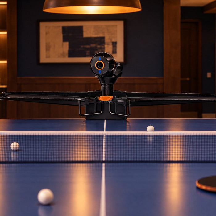 Best ping pong robot 2026: Pongbot Omni S Pro clamped to a blue table in a basement game room