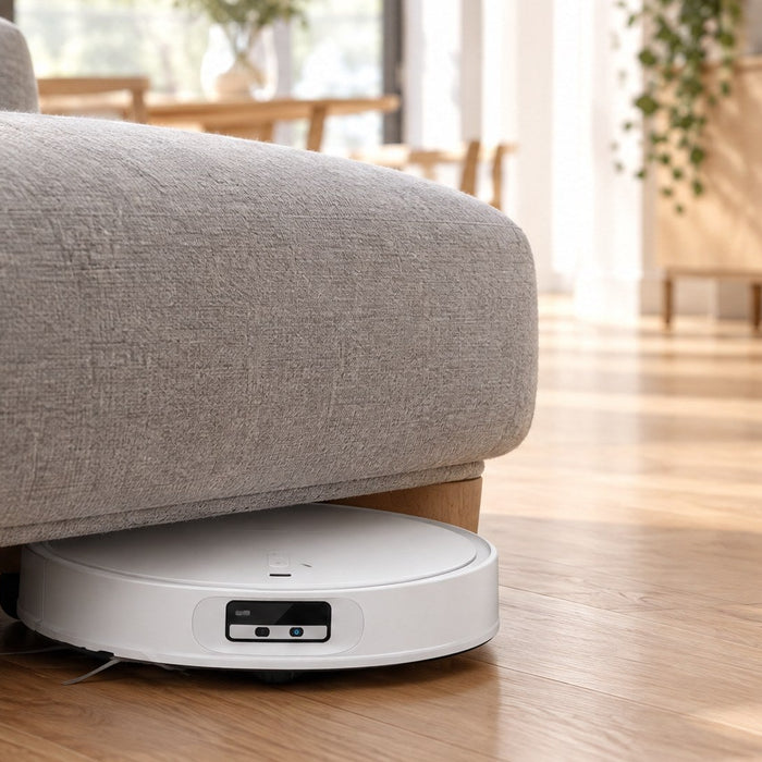 Slim Roborock Qrevo CurvX robot vacuum and mop cleaning under a low sofa on hardwood floors