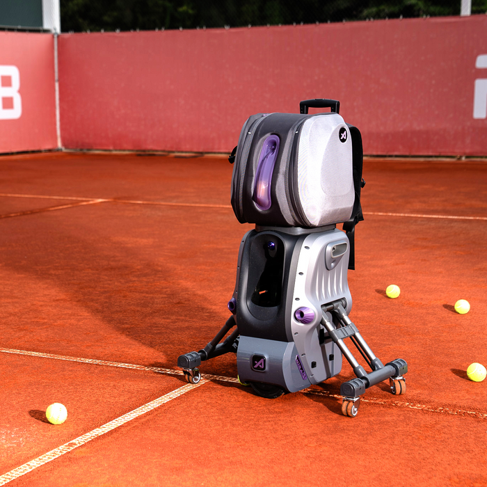 AceiiLab A1 tennis robot set up on a clay court with balls in play