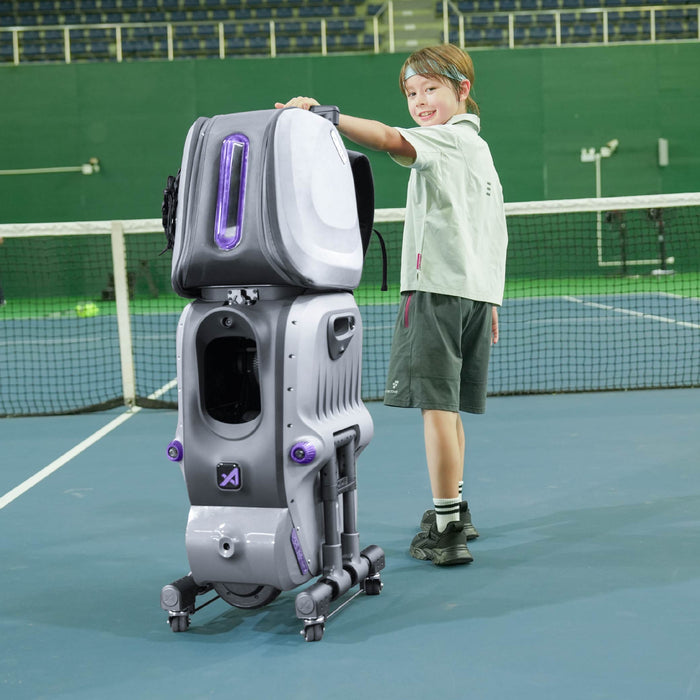 AceiiLab A1 tennis robot on a hard court with a young player
