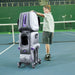 AceiiLab A1 tennis robot on a hard court with a young player